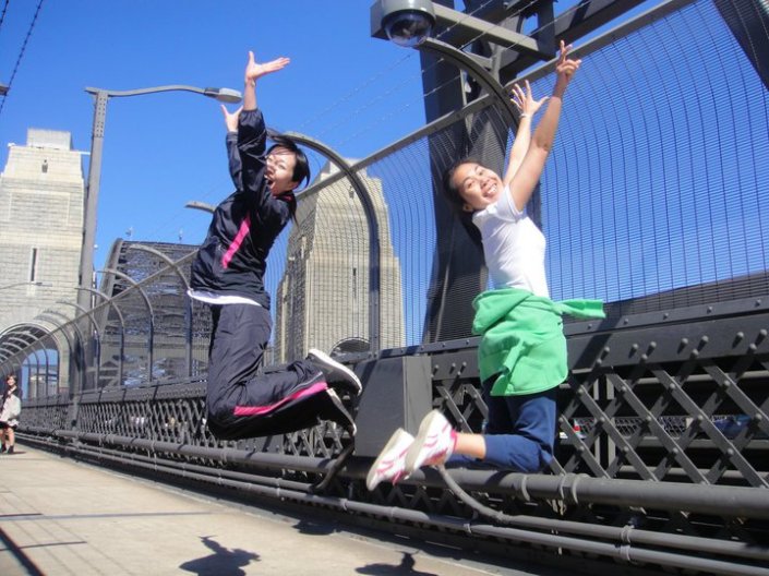 Mariko Kuribayashi jumping for joy with Jui PijaDa at the Global Launch on the Sydney Harbour Bridge