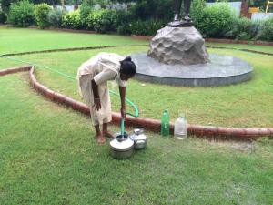 A lady fills her water containers from a hose that is constantly running in a park in Ahmedabad, India. Is this good that she has access to running water, or a concern that she is doing it in a way that is possibly unhygienic? How do we know when change is necessary or even possible?
